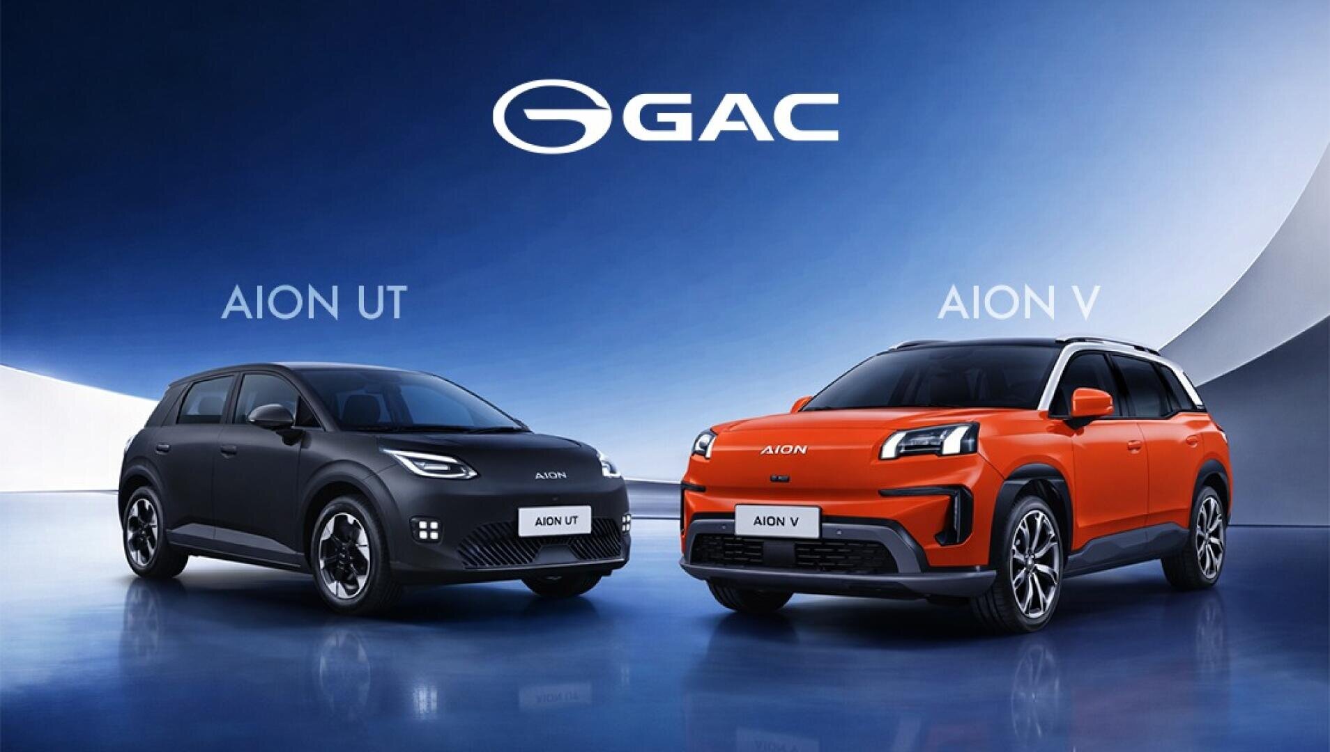 Zwei GAC-Elektroautos, der schwarze Aion UT und der orangefarbene Aion V, stehen nebeneinander in einem modernen Studio mit blauem und weißem Hintergrund und dem GAC-Logo darüber.