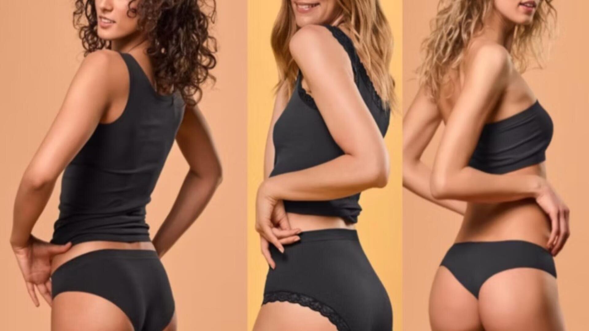 Drei Frauen in schwarzen Tanktops und schwarzer Unterwäsche posieren vor einem pfirsichfarbenen Hintergrund, wobei jede in einem anderen Winkel steht, um die Unterwäschestile zu präsentieren.